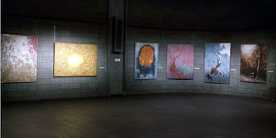 A row of Norman Lewis paintings in the concrete-walled gallery